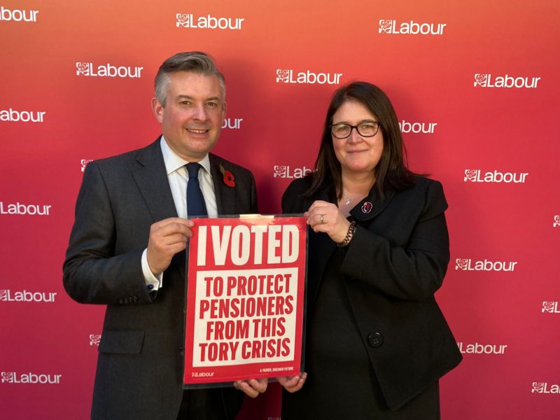 Rachel Hopkins MP and Jon Ashworth MP holding poster saying "I voted to protect pensioners from this Tory Crisis"