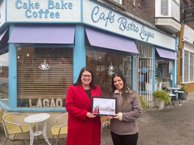 Rachel Hopkins MP presenting Small Business Awards certificate outside Cafe Lagoa