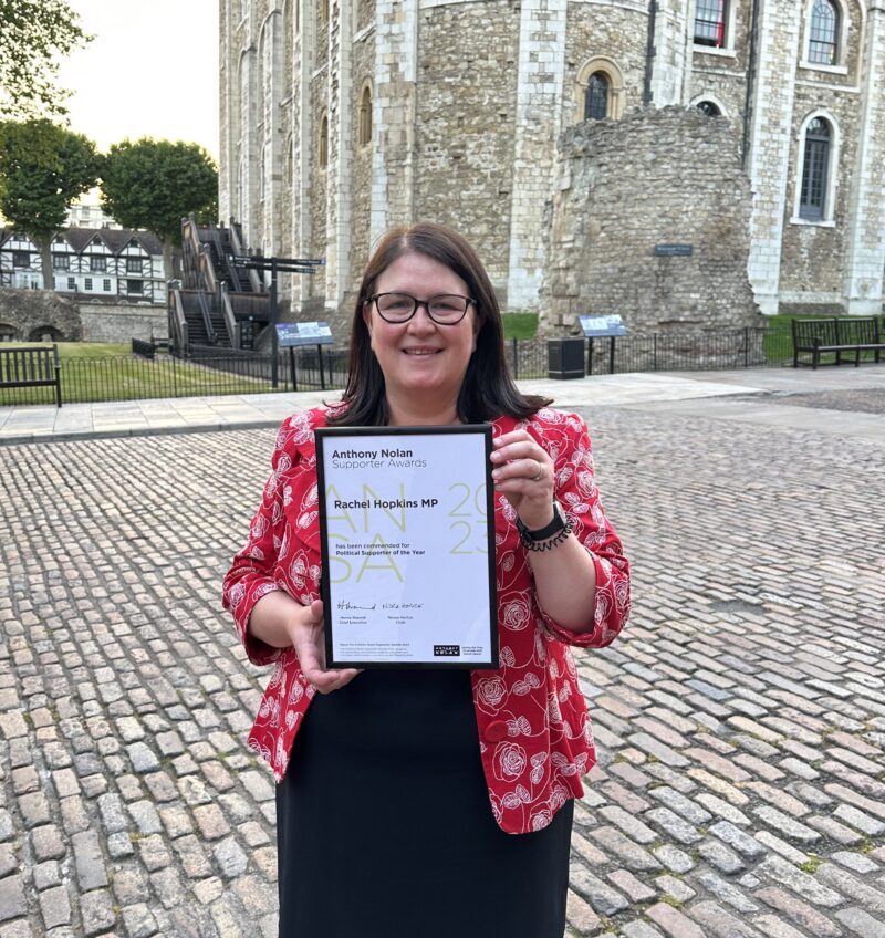 Rachel holding her certificate outside the Tower of London
